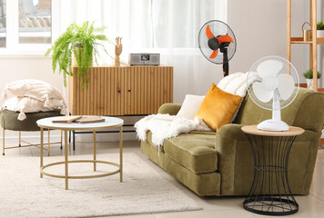 Interior of stylish living room with electric fans and sofa