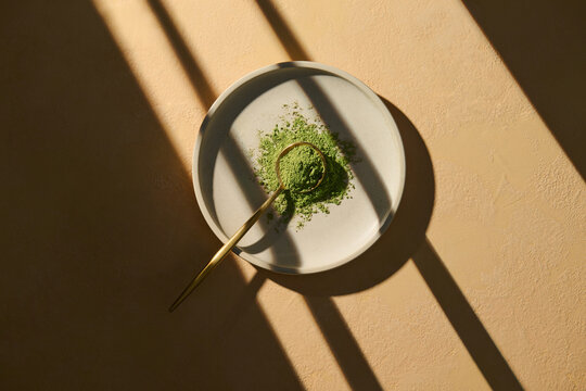 Flat Lay of Matcha Powder on Plate with Natural Light Shadows