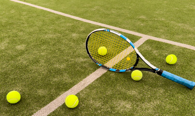 Tennis balls and racket on the grass court