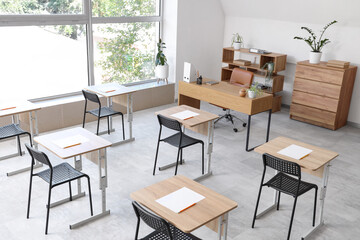 Interior of modern empty classroom prepared for exam