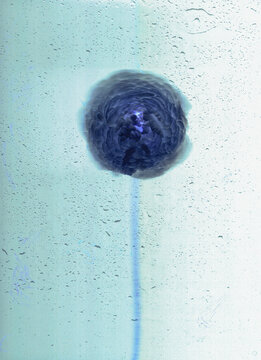 Abstract representation of a dark spherical shape in fluid