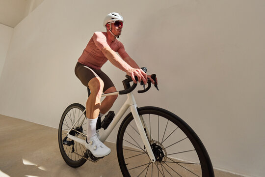 Cyclist navigating a minimalist indoor space during daytime