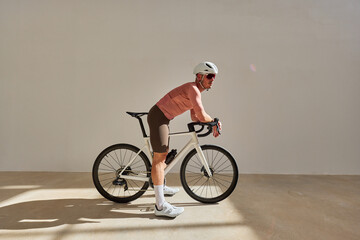 Cyclist preparing for a ride in a modern indoor setting