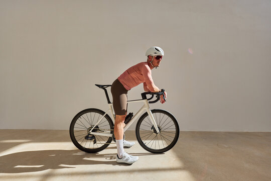 Cyclist preparing for a ride in a modern indoor setting