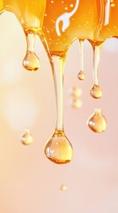 Close-up view of honey dripping and forming drops.