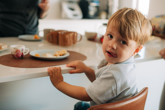 Toddler turned to look at camera at mealtime