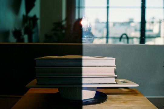 Analog photograph of a stack of books on top of a piece of tofu 