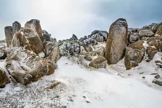 Sunshine over rock formations covered in ice rime