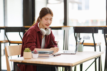 Young asian happy smiling Hispanic Asian student wearing headphones talking on online chat meeting...