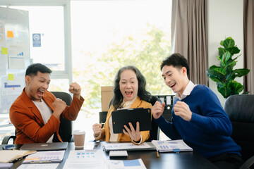 Group of young Asian business people discussing business plan at modern startup