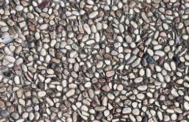 Garden or park close up stone pebbles pavement textures isolated on horizontal full frame background.