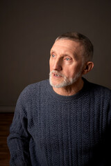 Authentic studio portrait of a handsome older man, selective focus.