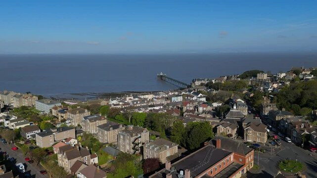 Clevedon town with historic pier and sea horizon looking across rooftops toward the Bristol Channel