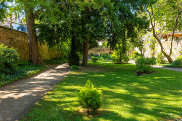 Lush garden paths invite tranquil strolls amidst vibrant greenery in the heart of a charming town