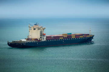 Arial view transportation logistics and container dock cargo yard with working crane bridge in...