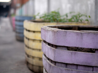 Colorful repurposed barrels used as compost bins outdoors