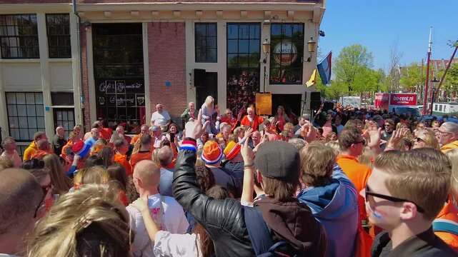 AMSTERDAM, NETHERLANDS - April 26, 2025: Locals celebrating kings day in the streets from Amsterdam the Netherlands