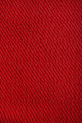 Red denim jeans texture close up. Red denim jeans background.
