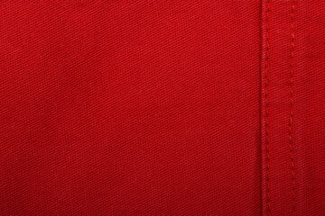 Red denim jeans texture close up. Red denim jeans background.