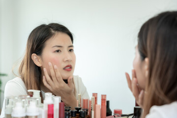 Young woman are worried about faces Dermatology and allergic to steroids in cosmetics. sensitive...