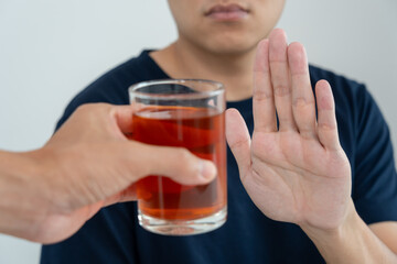 man refuses say no and avoid to drink an alcohol whiskey, stopping hand sign male, alcoholism treatment, alcohol addiction, quit booze, Stop Drinking Alcohol. Refuse Glass liquor, unhealthy, reject