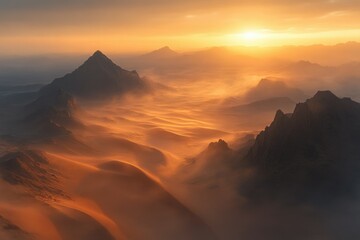 Majestic sunset over a desert landscape with windswept dunes and silhouetted mountains.