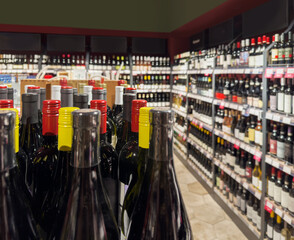 defocused alcohol (wine, champagne, liquor, whiskey) on store shelves