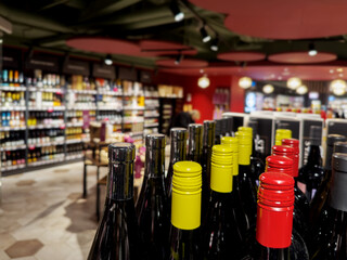 defocused alcohol (wine, champagne, liquor, whiskey) on store shelves