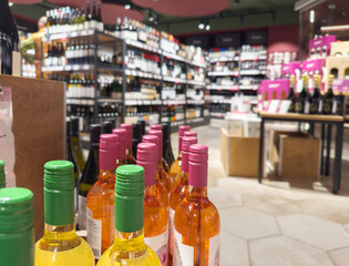 defocused alcohol (wine, champagne, liquor, whiskey) on store shelves