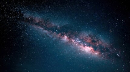 Fototapeta premium Mesmerizing view of the Milky Way galaxy at night, showcasing its stunning colors and cosmic details. A breathtaking sight!
