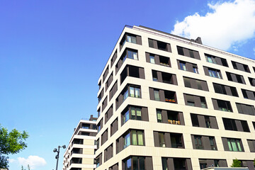 Construction industry - creation of modern multi-storey buildings. Condominium in Europe: facades of two recently occupied houses, finished with grey panels. Buying real estate in a new area