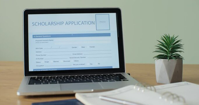 Laptop computer with an Scholarship Application form on its display.