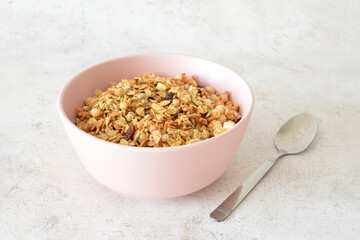 muesli in a Pink Bowl with a Spoon on marble background