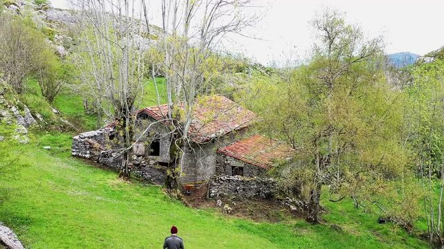 Man exploring ancient cabin in the mountains