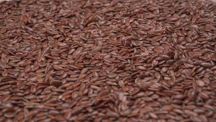 Brown flax seed or linseed on wooden background. Diet healthcare healthy food.
