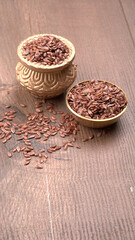 Brown flax seed or linseed on wooden background. Diet healthcare healthy food.