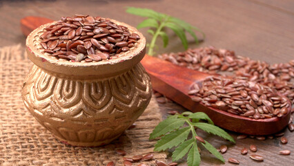 Brown flax seed or linseed on wooden background. Diet healthcare healthy food.