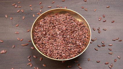 Brown flax seed or linseed on wooden background. Diet healthcare healthy food.