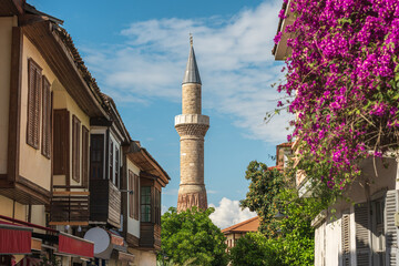 Naklejka premium Sehzade Korkut Mosque or Kesik Minaret, seen among the historical houses in the streets of Antalya Old Town