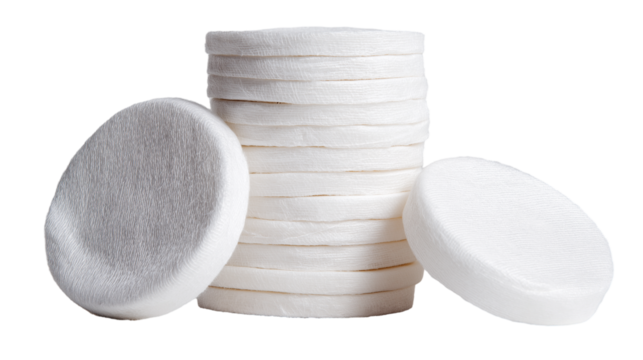 Stack of white round cotton pads isolated on white transparent background