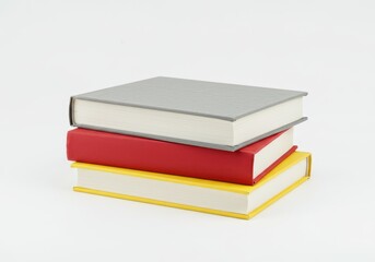 Stack of three closed hardcover books in gray, red, and yellow on a white background in a simple composition