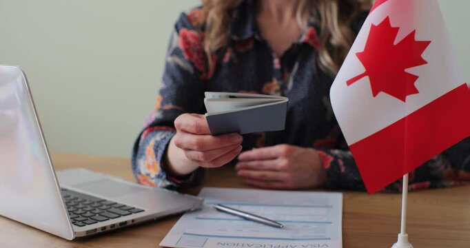 Canadian woman consular officer giving passport to male immigrant, work visa, citizenship. Visa Application online form immigration concept. Visa approval.