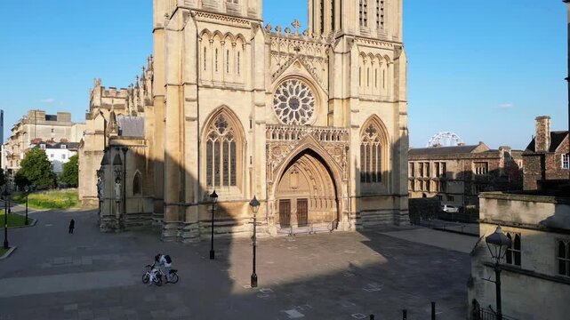 Drone shot of Ram Mohan Roy statue beside Bristol Cathedral, capturing historic architecture
