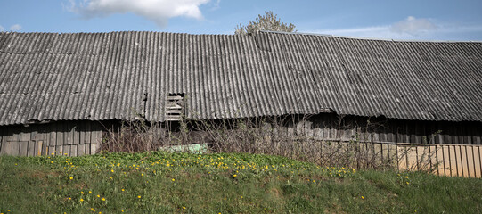 Old and very dangerous asbestos roof. Asbestos dust in the environment. Asbestos removal
