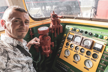 Man inside a classic vintage retro train steam locomotive Belarus.