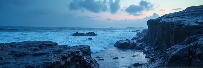 Majestic coastal landscape at dusk with rocky cliffs and ocean waves under a cloudy sky