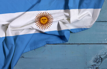 waving colorful national flag of Argentina on wooden table