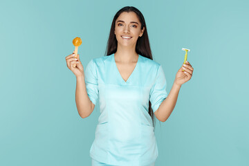 Cosmetologist holding sugaring paste and razor for depilation procedure over blue background