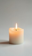 A single candle burns on a plain white surface with no visible background or flames, peaceful atmosphere, clean, simplicity