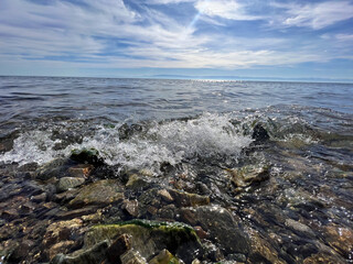 Captivating autumn wave at lake baikal with rocky shoreline under a cloudy sky